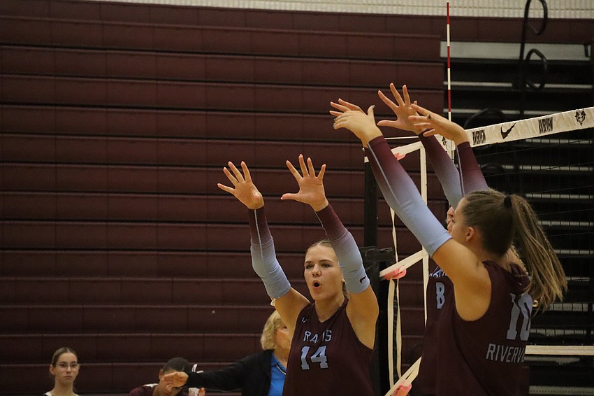 Jadyn Brester (14), Kate Grosso (8) and Brooke Rogers (10) celebrate after a point-winning block. All three operate as middle blockers for Riverview.