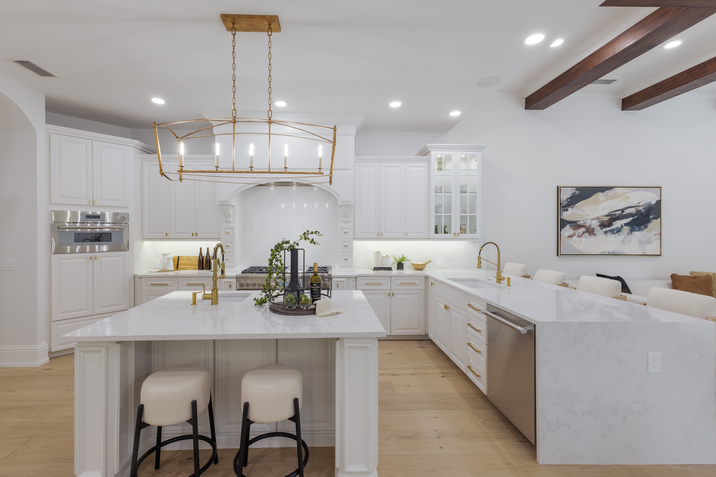 The brand-new kitchen offers a vast array of special features, including a professional-grade six-burner gas cooktop with griddle, double ovens, a wine fridge and two deep Kraus sinks with coordinating faucets.