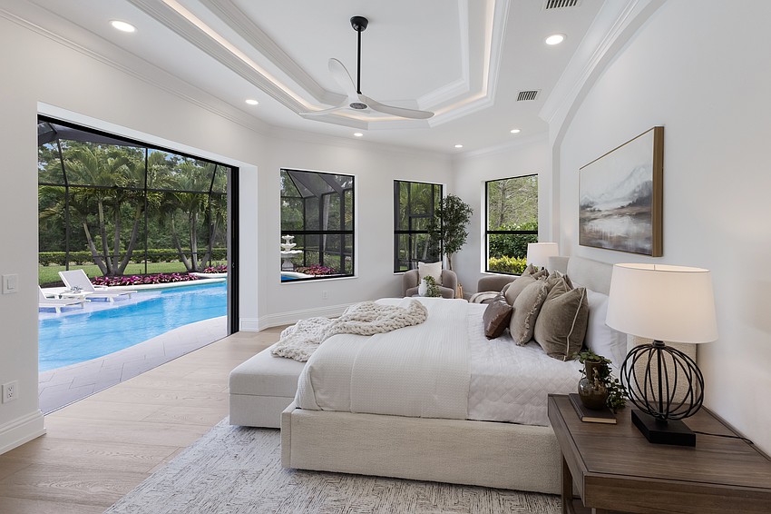 The spa-like primary suite features disappearing sliders to the pool, plus a cozy, light-filled seating area.