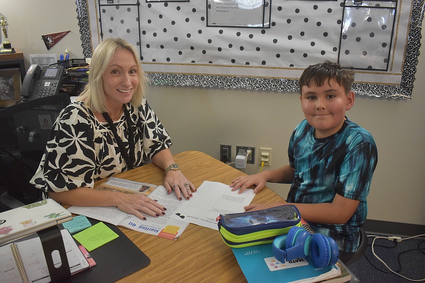 Fourth grade teacher Jenna Lewis works one on one with Tatum Cenizario. Cenizario said he misses his friends and teachers who transferred to Lake Manatee K-8, but hopes they have a great time and build new relationships.